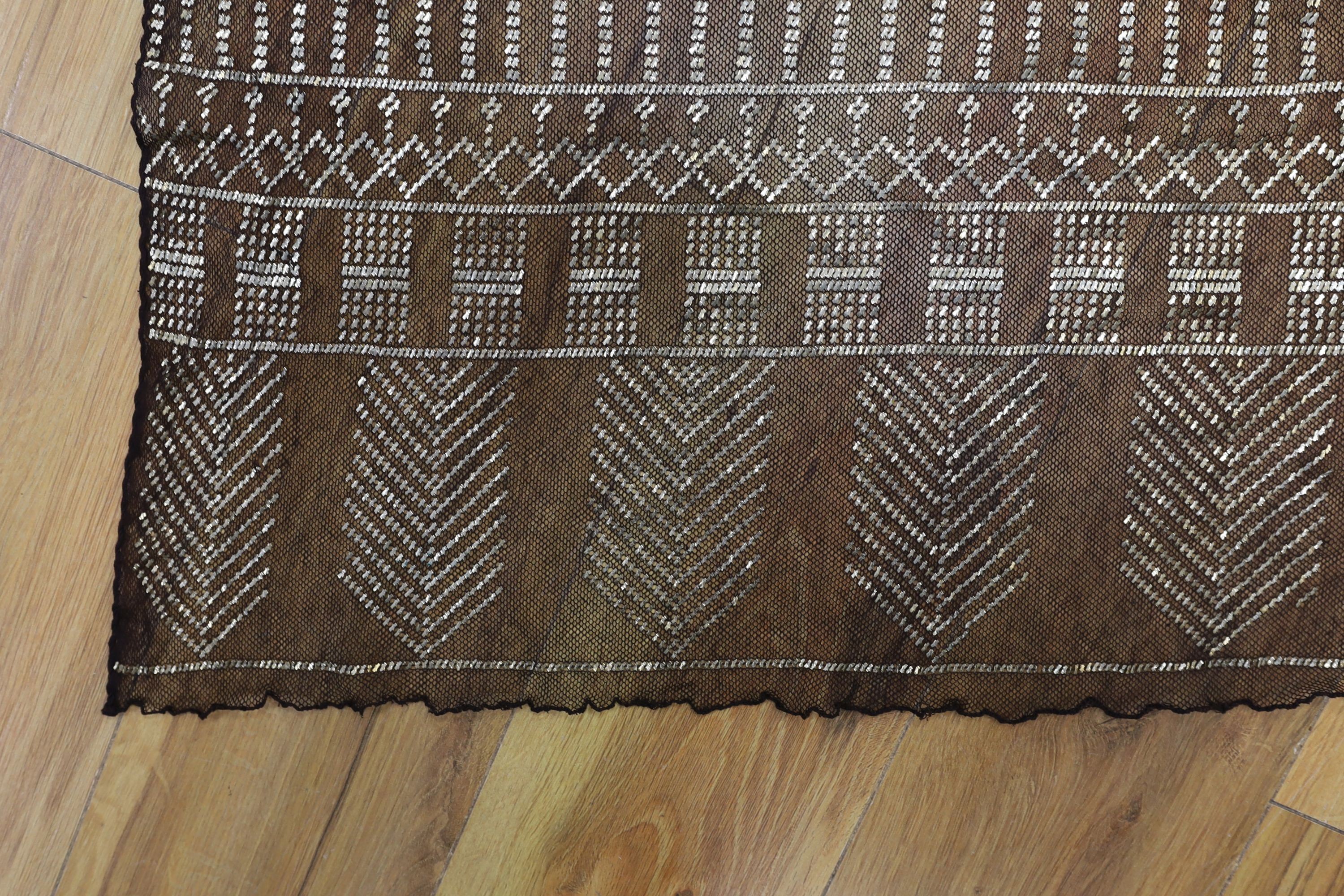 A dress made from a metal and black net Egyptian shawl; a similar shawl and a piece of shawl